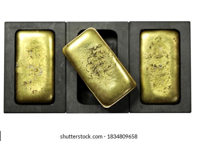 graphite molds with gold bars isolated on white background