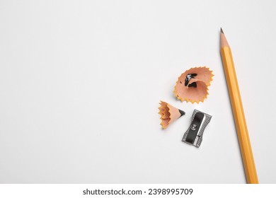 Graphite pencil, sharpener and shavings on white background, flat lay. Space for text - Powered by Shutterstock