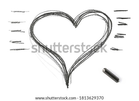 Graphite stick and grunge heart shape isolated on white background