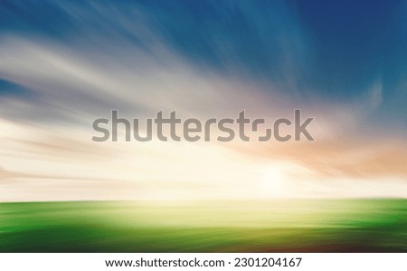 Grass and blue sky motion blur. Natural background