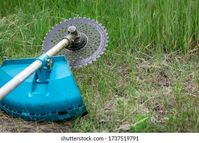 grass trimmer, lying on the ground, closeup blade