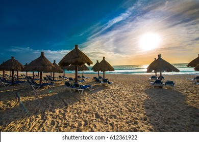 Grass Umbrellas And The Lounges On The Beach Of The Caribbean, Tropical, Mexican Luxury Resort.