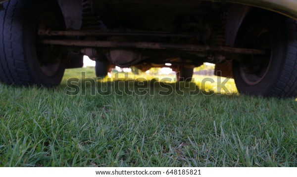 The\
grass under the car and background in dark of the\
car