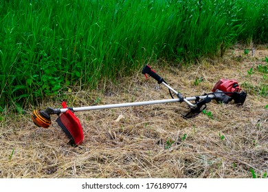 Grass-cutter. Hand mower trimmer. Natural background.