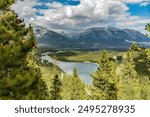 The Grassi Lakes trail hike in Canmore, Alberta during summertime with lake, town, woods, wilderness hiking area in Canadian Rockies from above, aerial view.