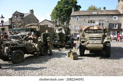 Grassington, Yorkshire, England, Britain, Sep 19th 2015. Man dressed as American medic from world war 2 sat in American Military jeep  in Grassington village square for a 1940s Nostalgia event.