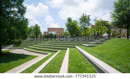 a grassy Amphitheatre with trees on the side