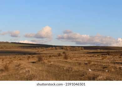 A grassy field with hills in the background - Powered by Shutterstock