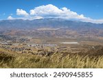 Grassy Field on a mountain ridge overlooking the town of Banning, CA and Mt San Gorgonio beyond taken in the foothills of Mt San Jacinto, CA