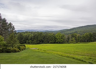 Grassy Field In Vermont With Mountains And Trees In Background