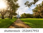 Grassy yard leading to white episcopal church building