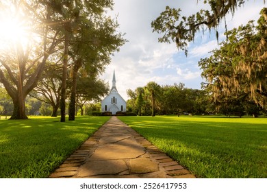 Grassy yard leading to white episcopal church building - Powered by Shutterstock