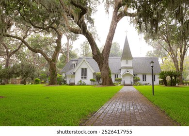 Grassy yard leading to white episcopal church building - Powered by Shutterstock