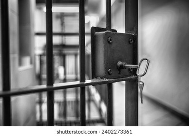 Grate with a key to a prison cell. Arrest.