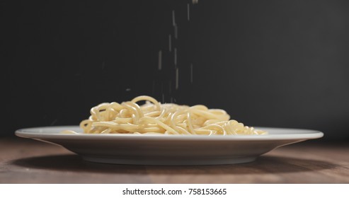 Grated Aged Parmesan Cheese Falling On Spaghetti