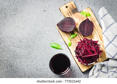 Grated beetroot in a bowl and beet juice. Top view, copy space.