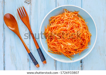 Grated carrots salad with garlic. Top view.