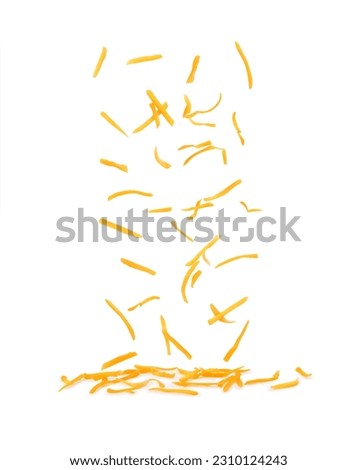 Grated cheese falls on a white background