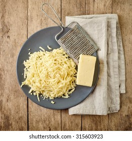 Grated Cheese On Wooden Table, Top View