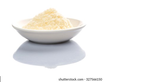 Grated Cheese In A White Bowl Over White Background