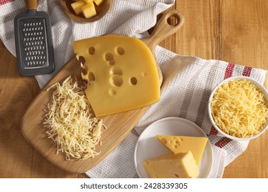 Grated, cut cheese and grater on wooden table, flat lay - Powered by Shutterstock