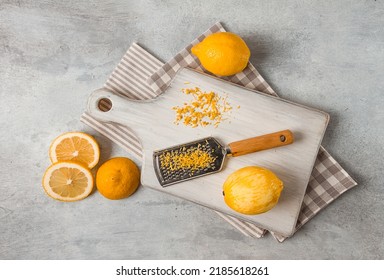 Grated lemon zest, on a cutting board, with a grater , top view, no people,