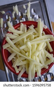 Grated Monterrey Jack Cheese In Red Ceramic Bowl. 