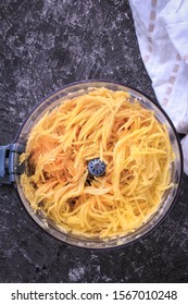 Grated Potato Into A Food Processor. Grated Potato Prepared For Making Potato Pancakes, Draniki, Deruny, Potato Latkes. Grated Raw Potatoes.