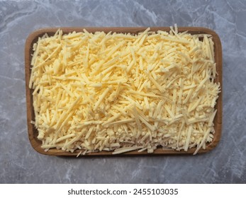 Grated Or Shredded Cheese On A Wooden Plate. Food Menu. Top View. - Powered by Shutterstock