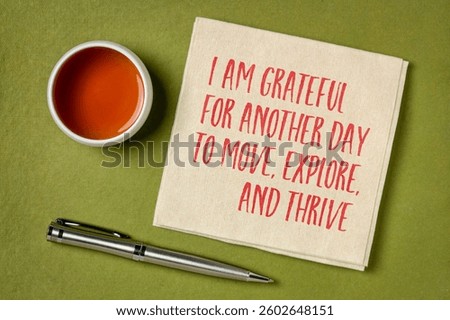 I am grateful for another day to move, explore and thrive - morning positive affirmation on a napkin with tea