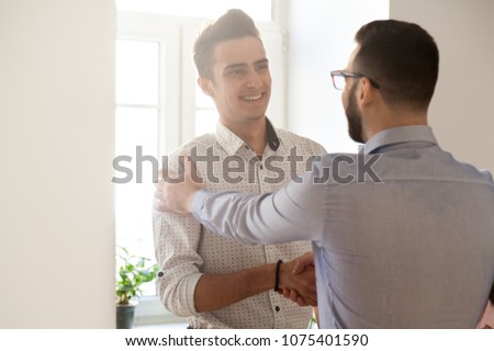 Grateful boss handshaking employee congratulating with job promotion, appreciating good results, friendly ceo proud of subordinate shaking hand expressing gratitude, recognition, support and respect