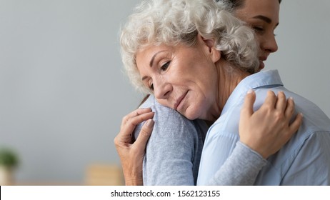 Grateful Calm Senior Grandma Mother Embrace Young Adult Daughter Hug Grandchild, Two Age Generations Women Bonding Give Support And Comfort, Helping Sharing Love Care With Older Grandparent Concept