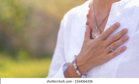 Gratefulness – Woman expressing gratitude with hands. Close up image of female hands in prayer position outdoor. Self-care practice for wellbeing - Shutterstock ID 1564066336