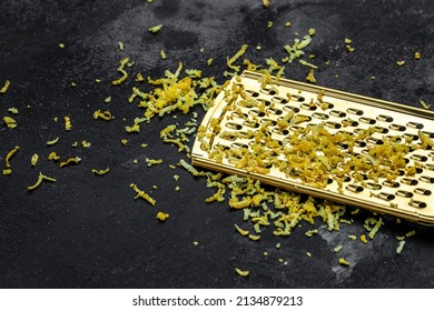 Grater Peel And Lemon Zest Ready To Cook On Black Background, Long Banner Format. Top View.