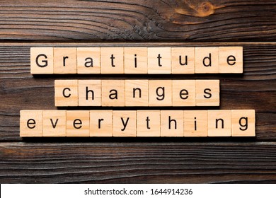 Gratitude changes everything word written on wood block. Gratitude changes everything text on wooden table for your desing, concept.