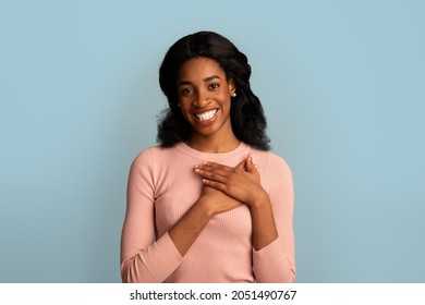 Gratitude Concept. Thankful African American Female Keeping Both Palms On Chest, Grateful Black Woman Expressing Appreciation And Kindness While Standing Over Blue Background, Copy Space