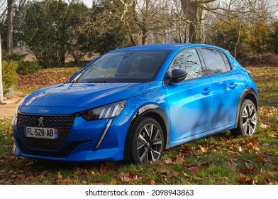 Graulhet, France - Dec. 2020 - Three-quarter view of a blue, modern Peugeot 208 II compact car in a garden, a model produced by the French car manufacturer PSA Peugeot-Citroën (Stellantis Group)