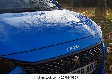 Graulhet, France - Dec. 2021 - Detail of the front hood and aluminum radiator grille of a Peugeot 208 II GT Line, a high-end model of compact car made by the French manufacturer PSA Peugeot-Citroën