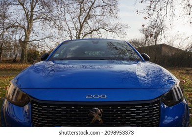 Graulhet, France - Dec. 2021 -Front hood, Lion logo and aluminum radiator grille of a Peugeot 208 II GT Line, a high-end model of compact car made by the French manufacturer PSA Peugeot-Citroën