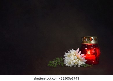 Grave candle lantern and flower on dark grunge background with copy space - Shutterstock ID 2350061743