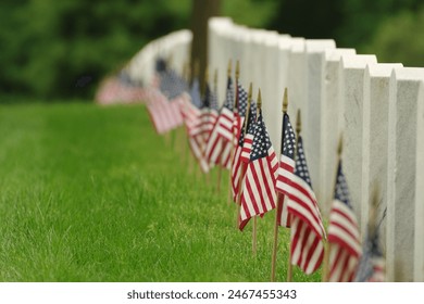 Grave markers with American flags at Arlington National Cemetery. - Powered by Shutterstock