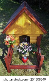 The Grave Of A Pet. Wooden Dog House Monument.