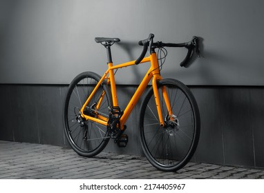 Gravel Bicycle. Orange Bike For Cross Country Cycling On Grey Background.