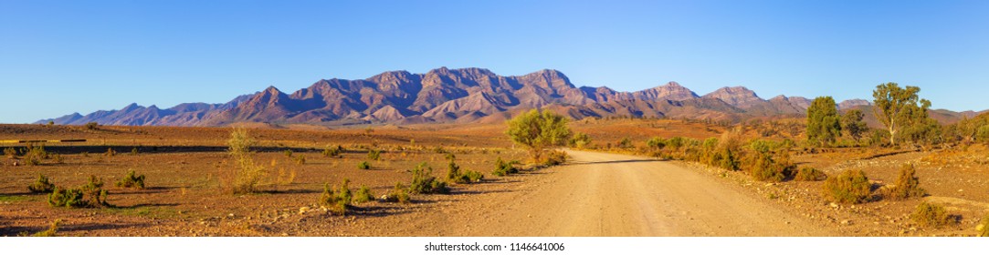 Gravel countryside road leading to rugged peaks of Flinders Ranges mountains in South Australia