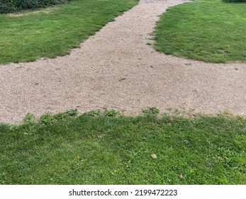 A Gravel Path Junction On A Green Meadow