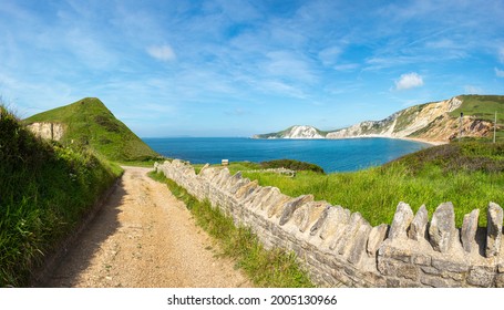 Gravel Path From Tyneham Village Leading To Worbarrow Bay And Jurassic Cliffs With Old Stone Wall On A Bright Summers Day. Used By The Army For Training And Target Practice, No People.