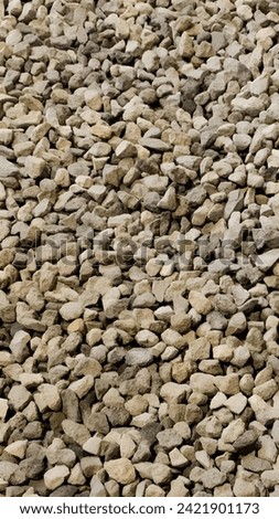 Gravel pile stacked on wooden pallet.