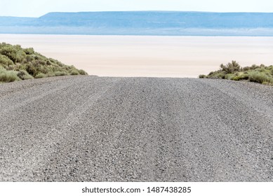 Gravel road with the Alvord Desert in the background in southeast Oregon