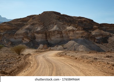 Gravel road and mountain landscape in Oman