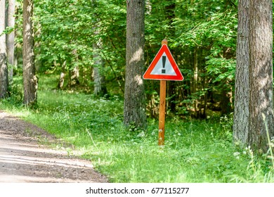 gravel road in sunny summer countryside with perspective and bright red attention sign - Shutterstock ID 677115277